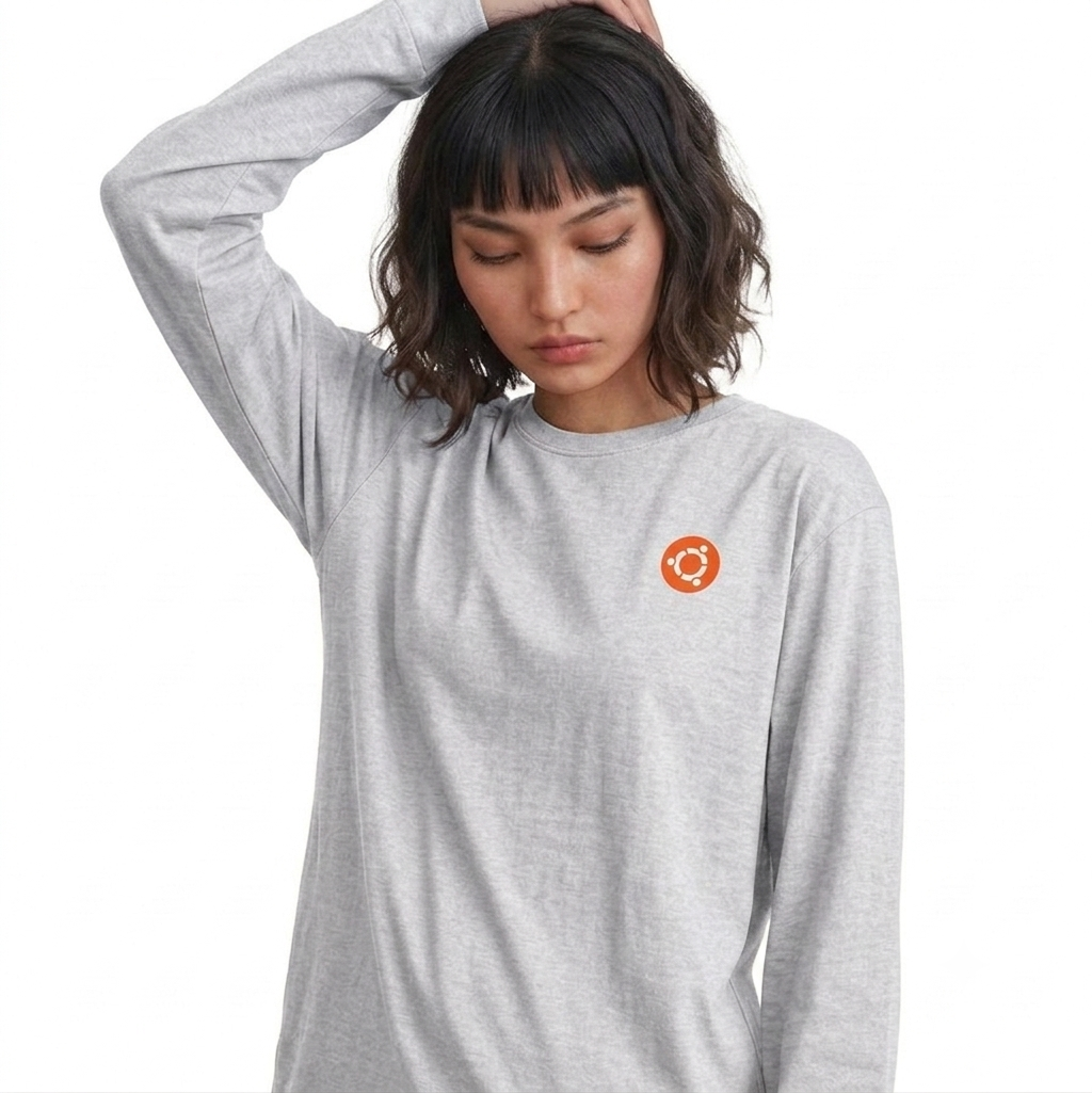 Woman wearing a gray long-sleeve shirt with an orange logo on a white background